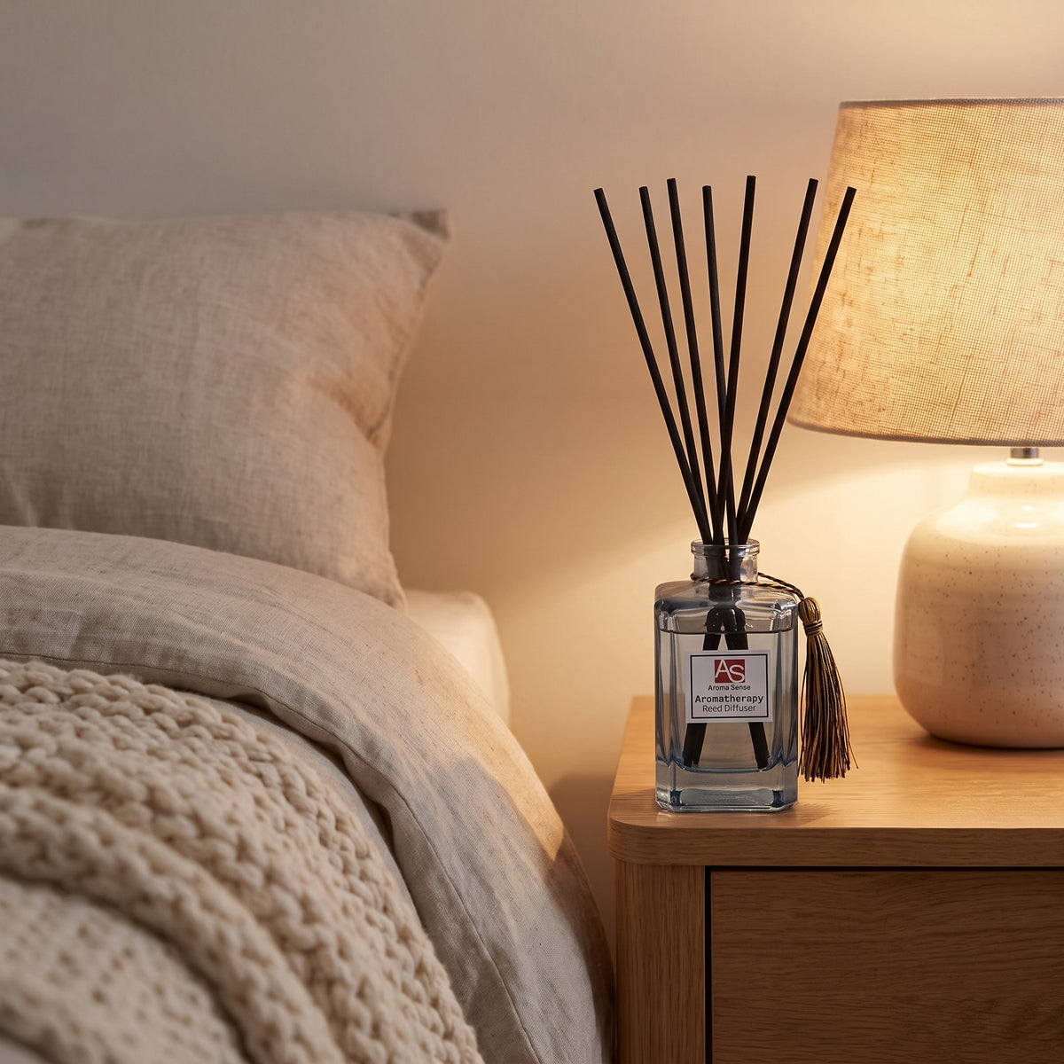Aroma Sense 150ml reed diffuser on a bedside table
