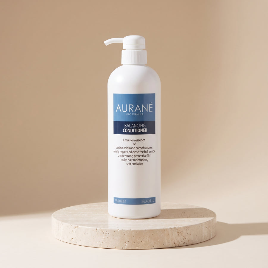 Aurané Balancing Conditioner 750ml on a travertine stand