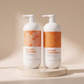 Aurané Keratin Shampoo and Conditioner set, 1000ml each, on a travertine stand