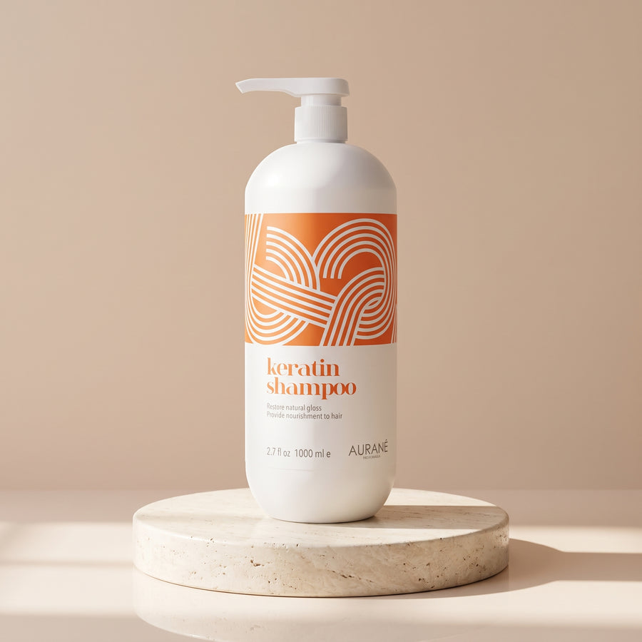 Aurané Keratin Shampoo 1000ml on a travertine stand